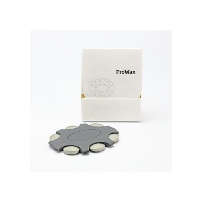 A small white box labeled Bernafon ProWax stands behind a gray, circular dispenser filled with several white Bernafon ProWax filters arranged around the edge.
