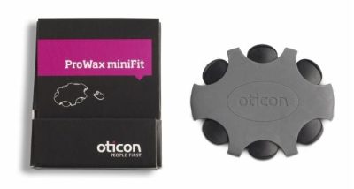 A box labeled Oticon ProWax miniFit is pictured beside a gray, round plastic dispenser that holds small wax guards for hearing aids.