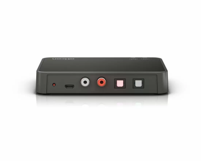 A black Oticon TV adapter 3.0 is shown from the back on a plain white background, displaying USB-C, red and white audio jacks, and two digital optical audio ports.